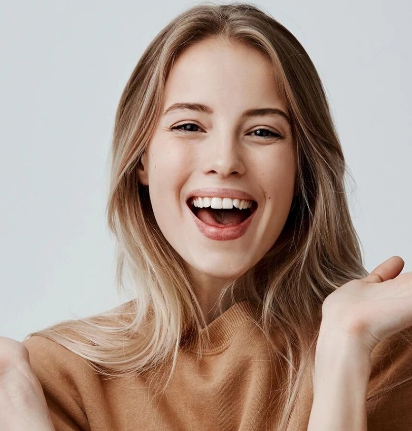A client laughing after an in-chair whitening session